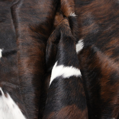 Chocolate and white cowhide rug